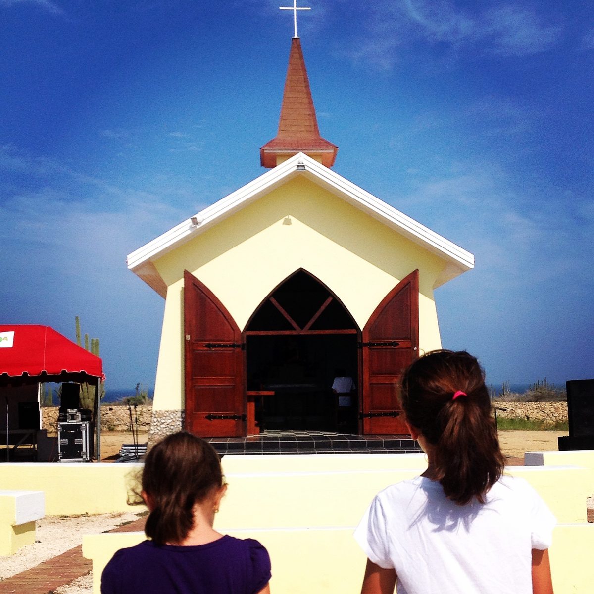 The bright-yellow Alto Vista Chapel on a hill in Aruba