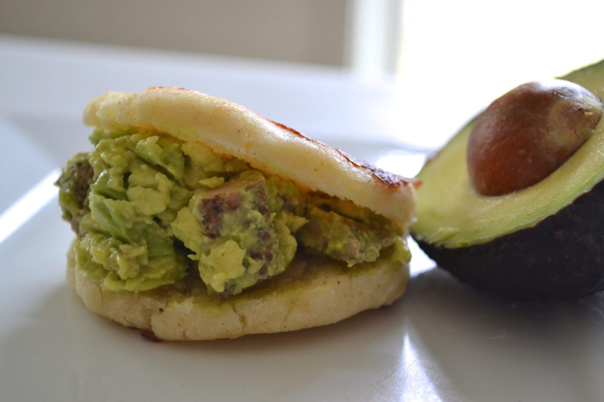 Stuffed arepa filled with avocado, a Venezuelan-style corn cake found at Aruba street-food stands