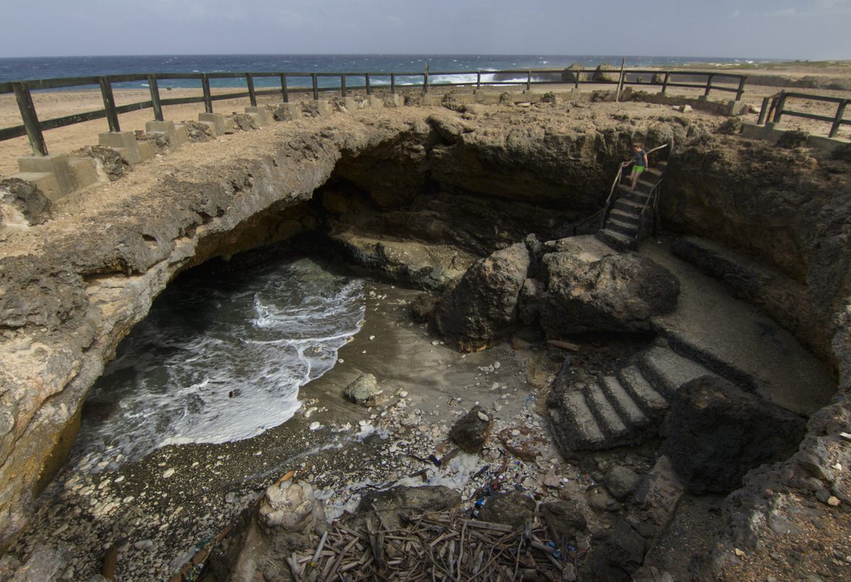 Rugged coastline in Arikok National Park, Aruba, typically reached on a paid jeep or UTV tour