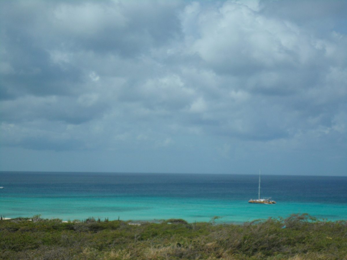 Catamaran on turquoise water off Aruba, a classic Aruba excursion