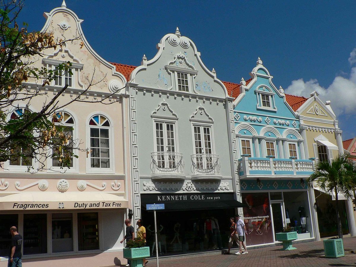 Duty and tax-free fragrance and fashion storefronts on a downtown Oranjestad shopping street in Aruba