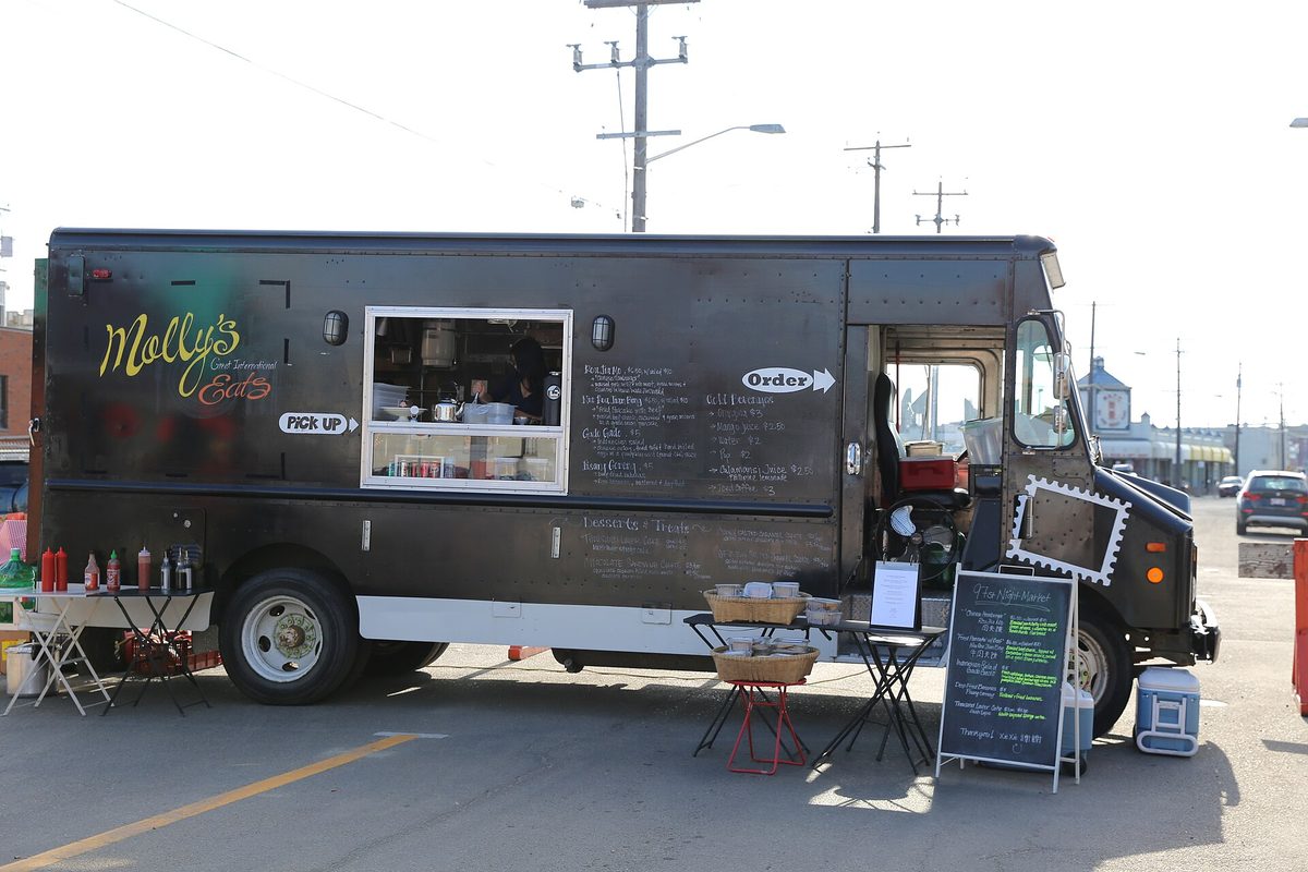 Brightly lit aruba food trucks serving late-night street food under string lights