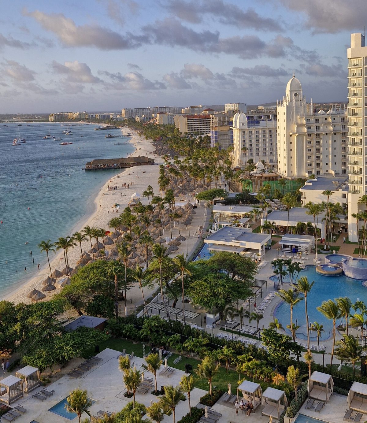 Aruba's Palm Beach high-rise resort strip with white sand, palms and turquoise water