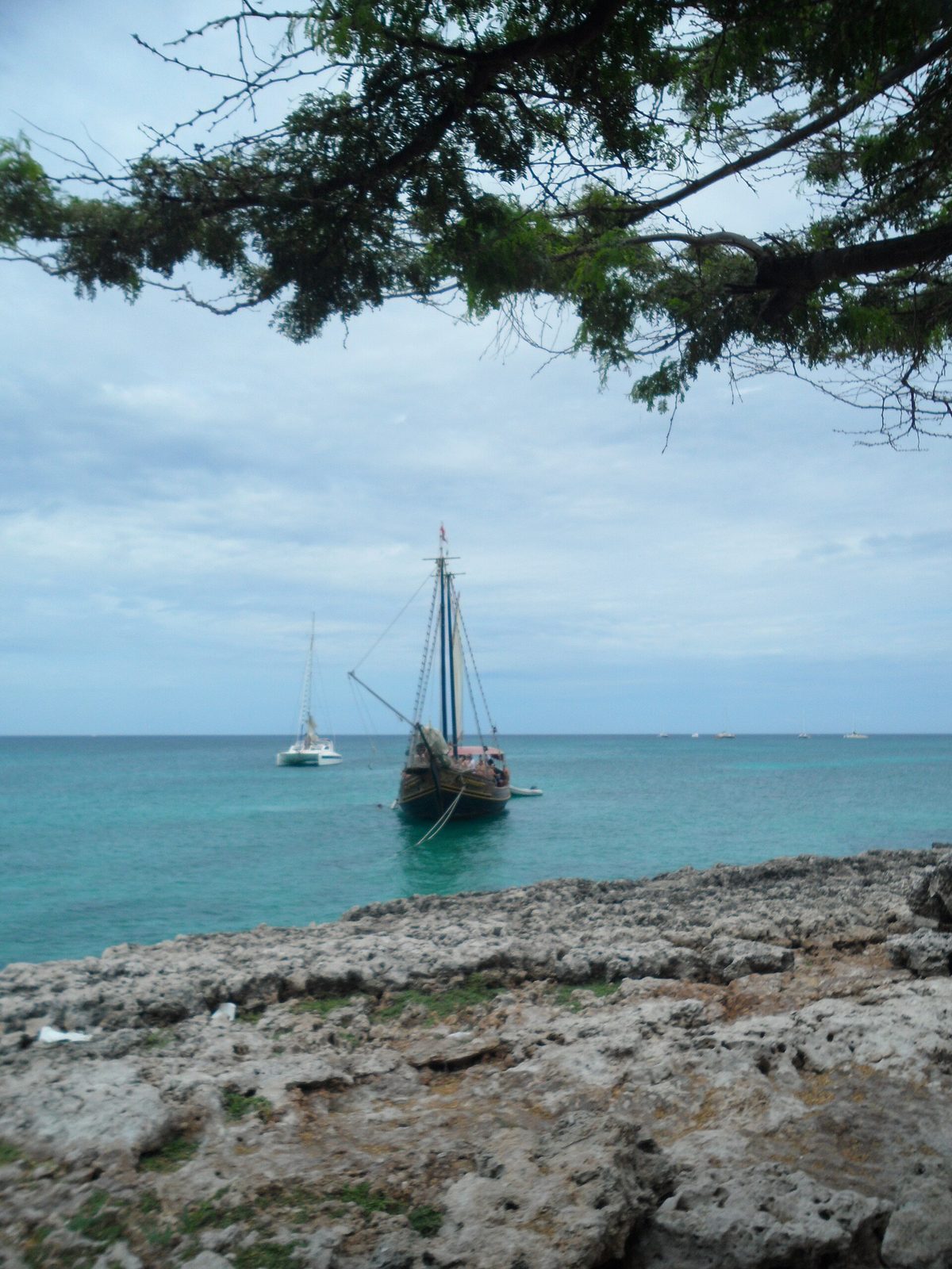 Snorkel-cruise boats anchored off the rocky Malmok and Boca Catalina coast in Aruba