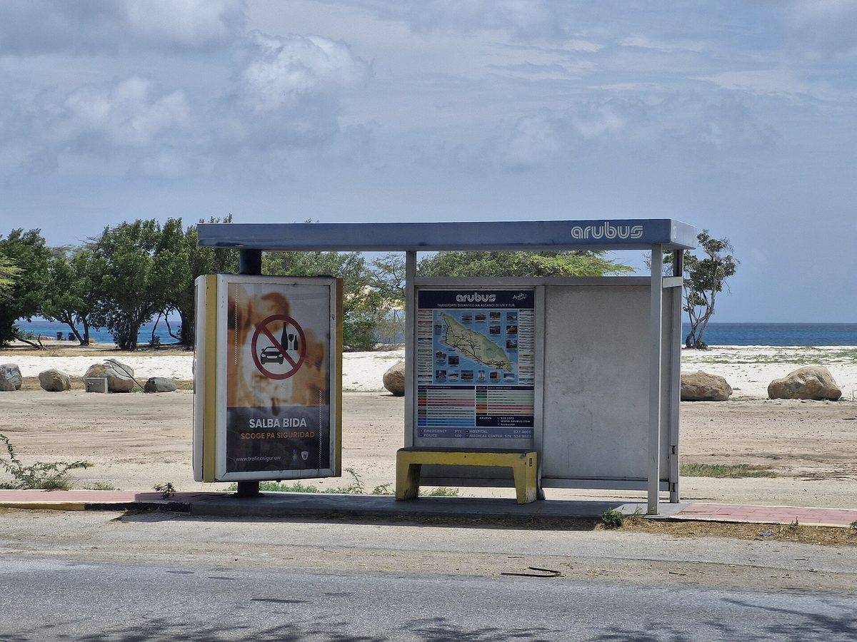 An Arubus public bus stop in Aruba, marking the cheap public-transport route along the coast