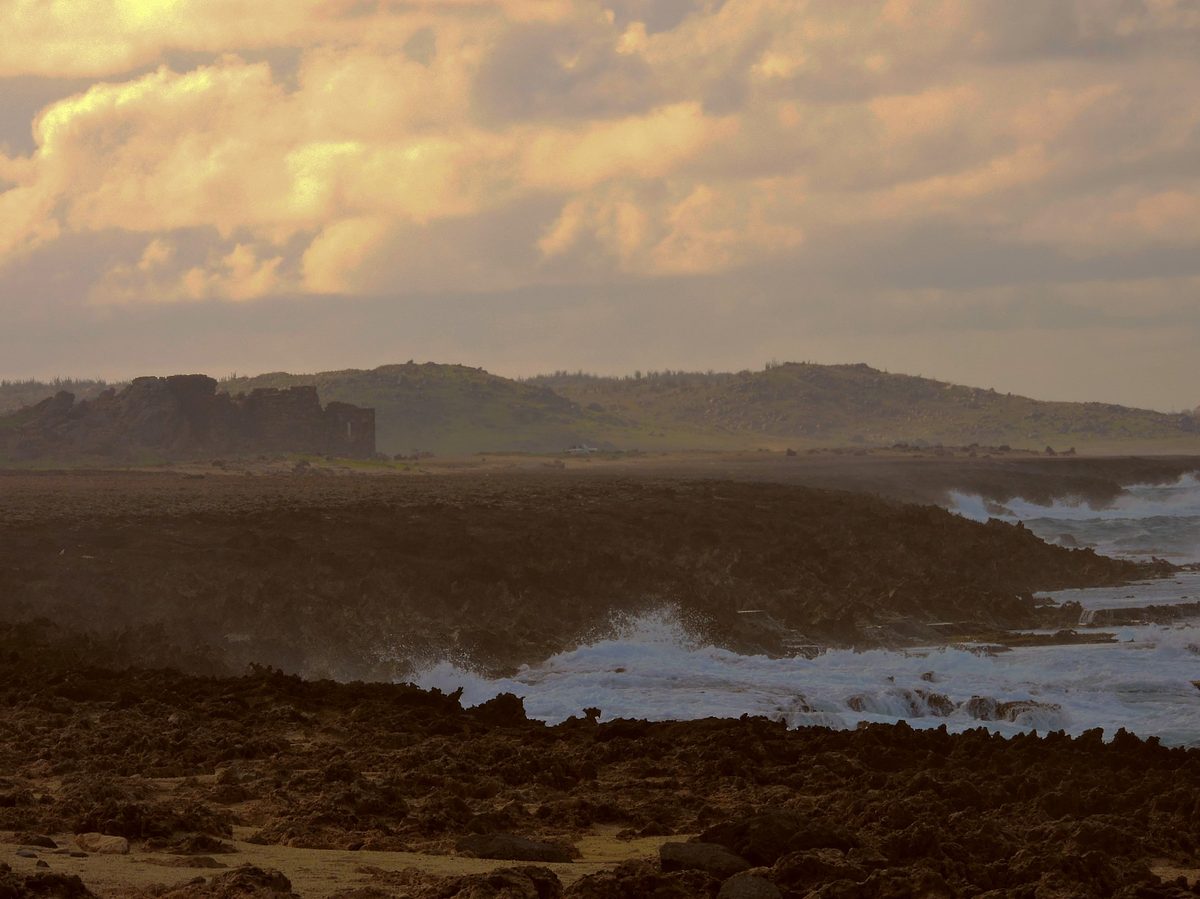 Stone walls of the Bushiribana Gold Mill ruins on Aruba's north coast near the Natural Bridge at golden hour