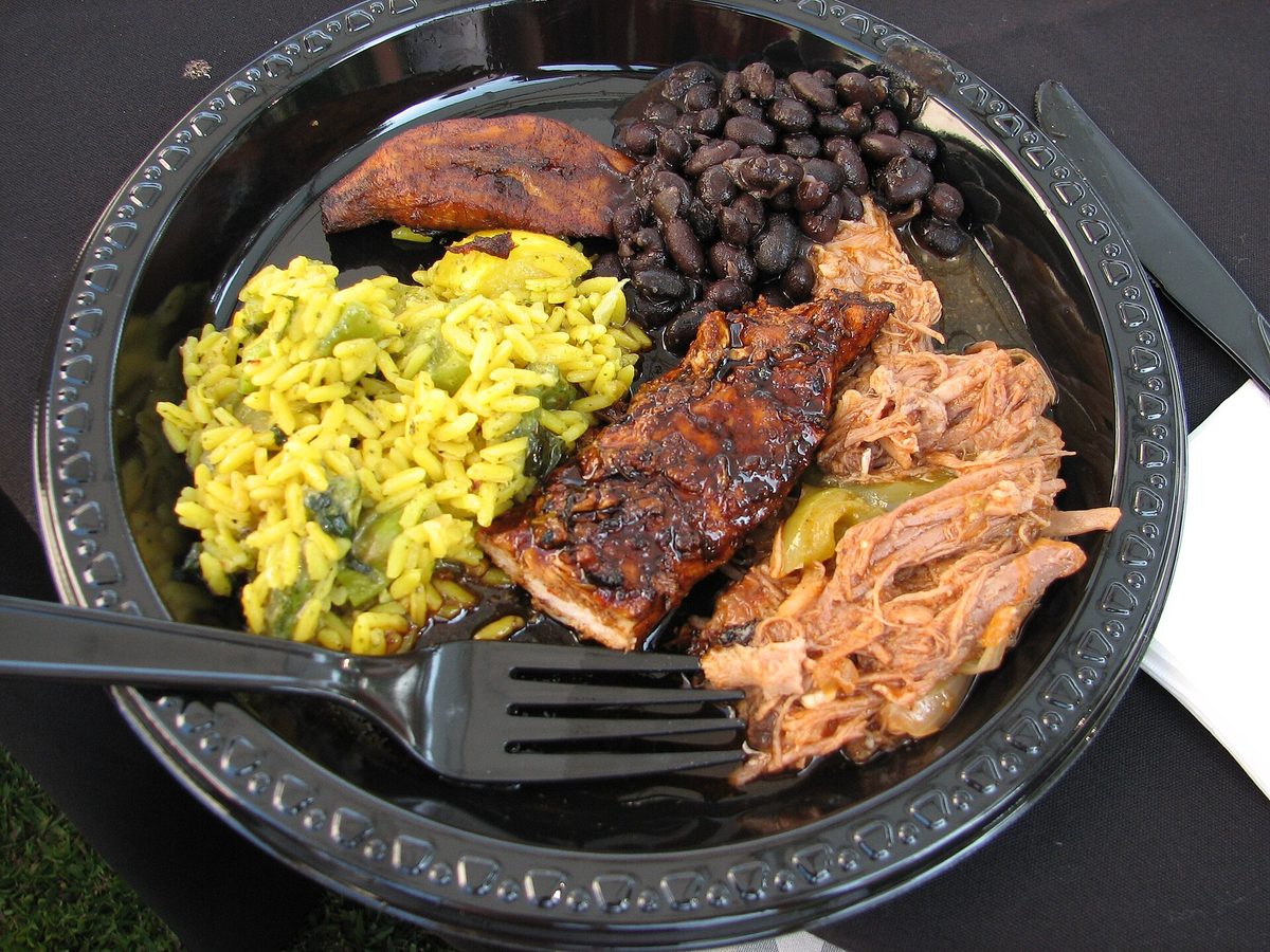 A hearty Caribbean dinner plate with rice, beans, plantain and grilled meat