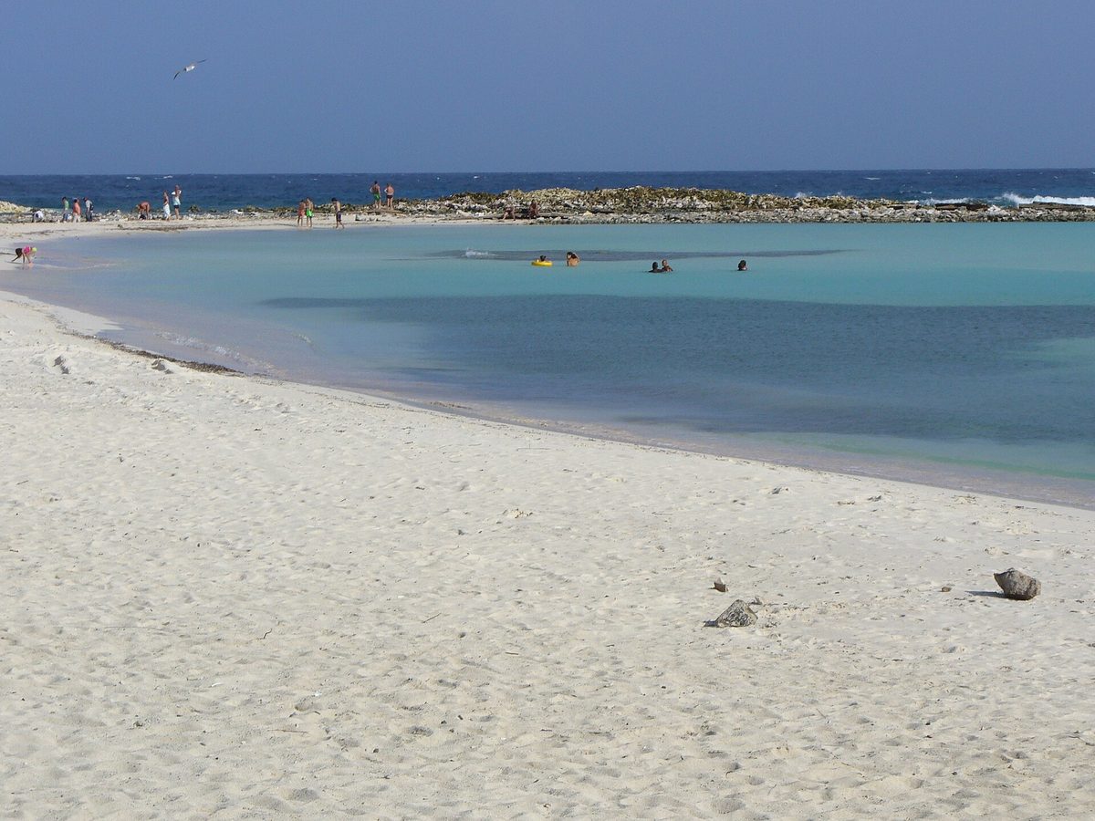 The sheltered turquoise lagoon and white sand of Baby Beach in southern Aruba