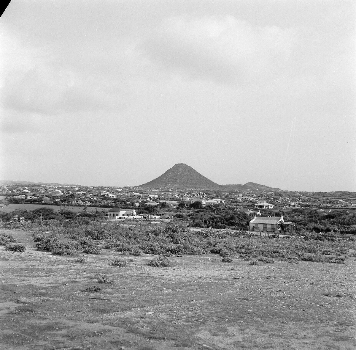 The cone-shaped Hooiberg, Aruba's Haystack hill, rising over the central landscape