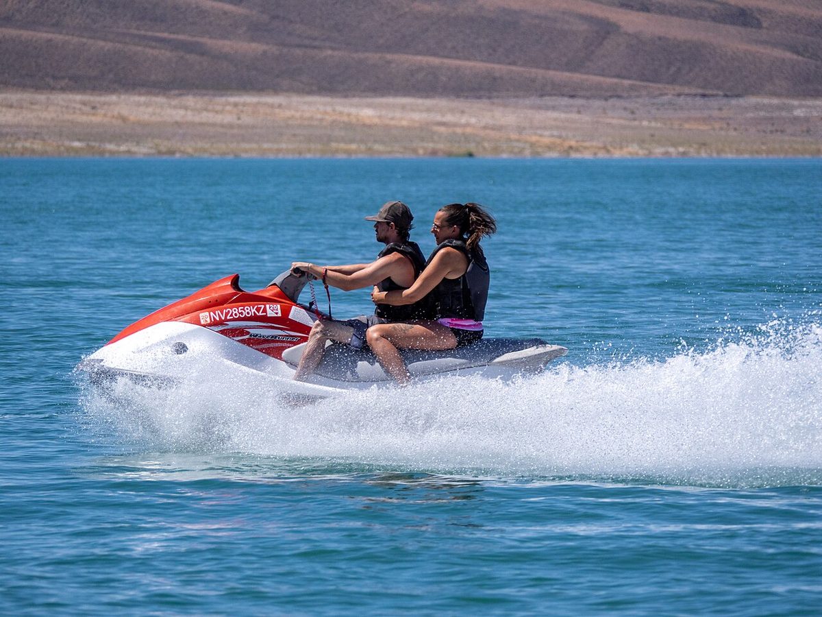 Riding an Aruba jet ski across calm turquoise Caribbean water off Palm Beach