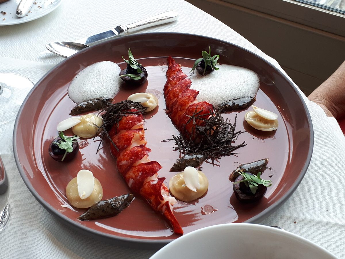 Fresh lobster tail plated with foam and garnish, the kind of seafood you'll find at Aruba's beachfront restaurants