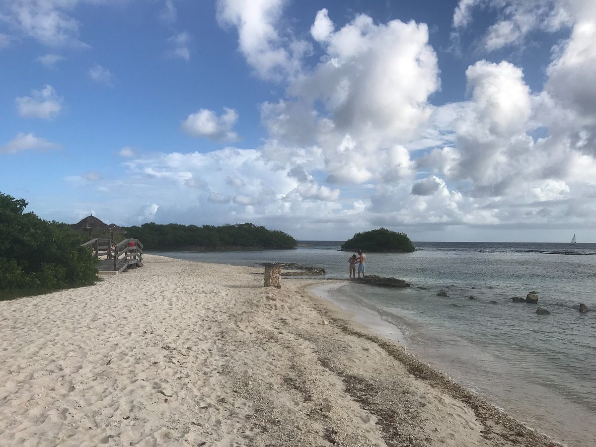 The white-sand cove, wooden sun deck and calm turquoise lagoon at Mangel Halto, Aruba
