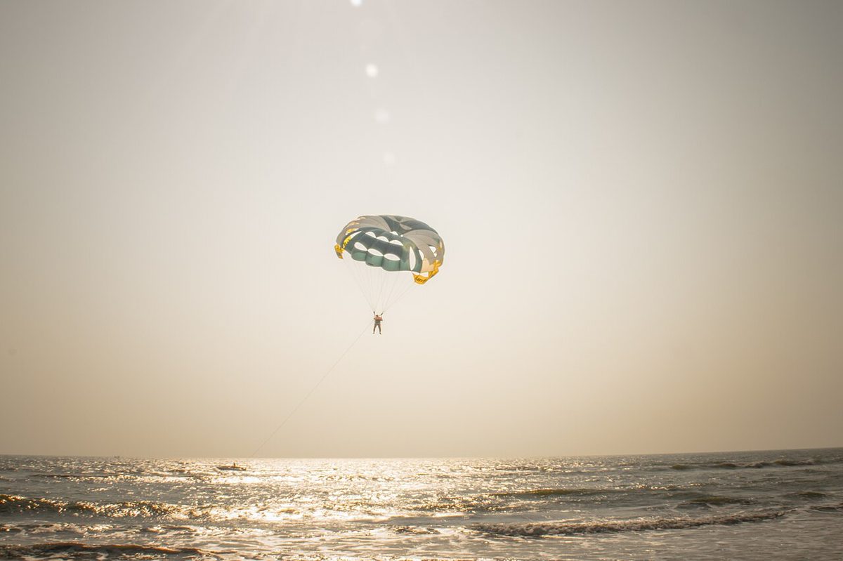 Parasailing high above a turquoise Caribbean beach in Aruba