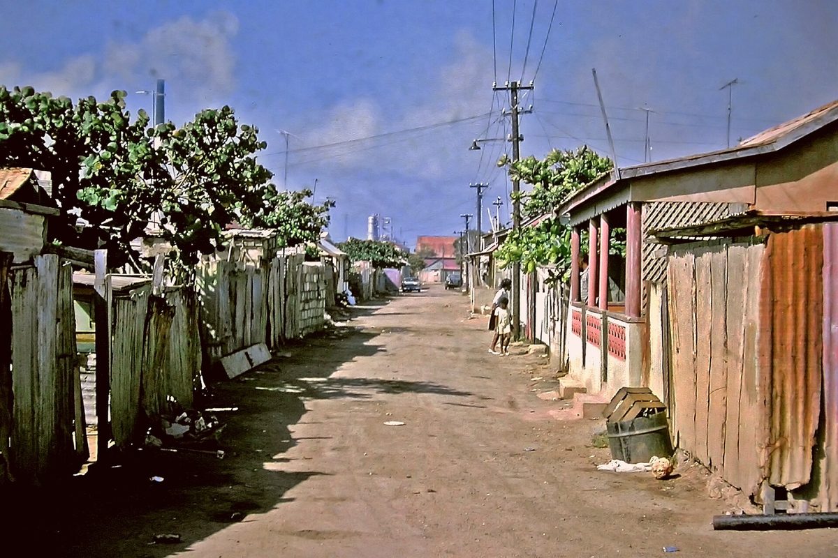 A historic San Nicolas street with the old Lago refinery in the distance, Aruba