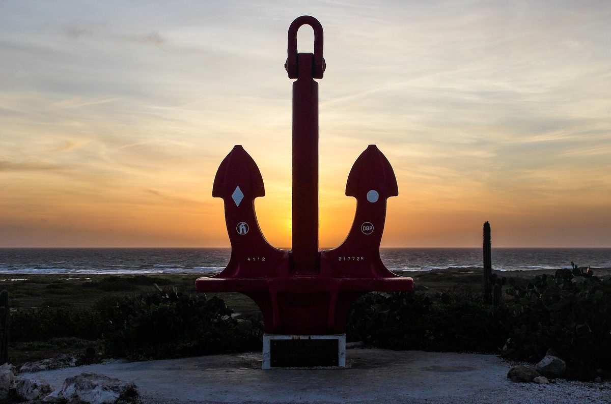 The Big Red Anchor monument near San Nicolas, Aruba, at sunrise