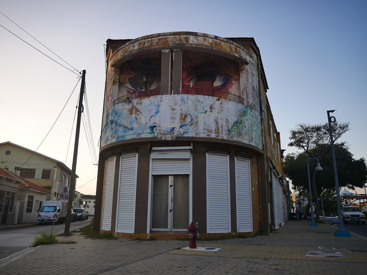 Colorful street-art mural on a building in San Nicolas, a short drive from Baby Beach Aruba