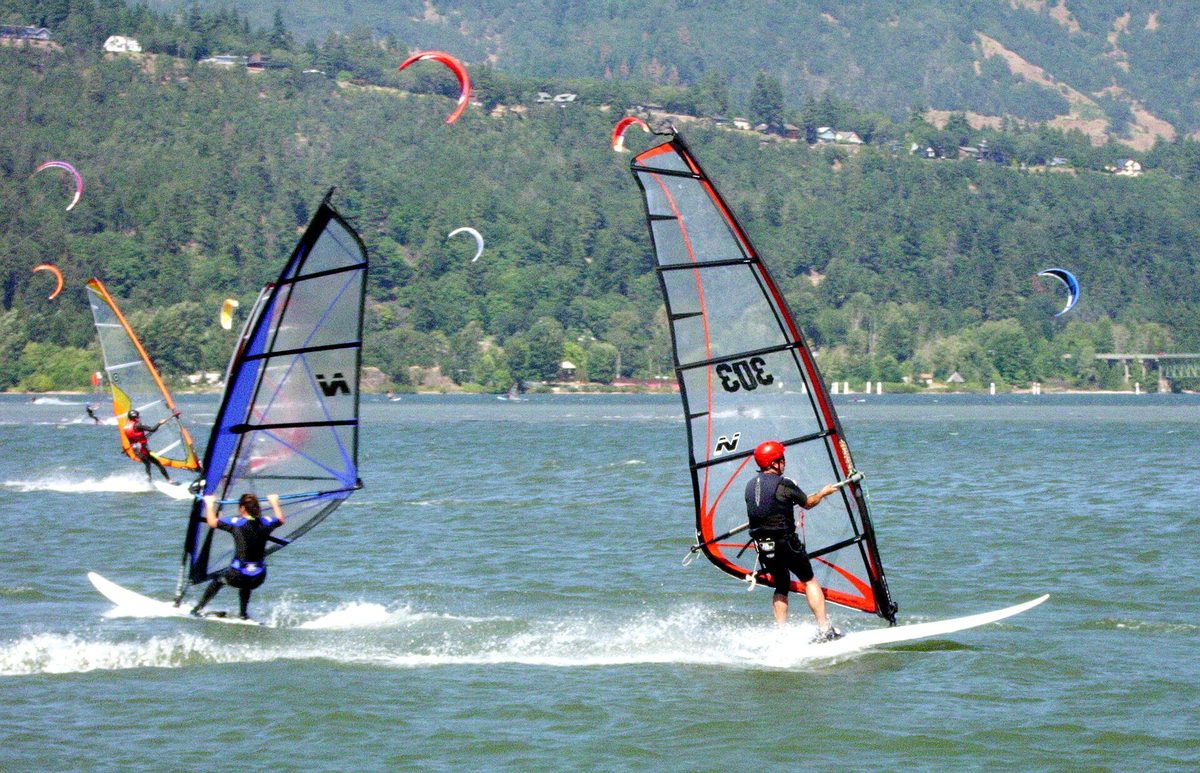Windsurfing in Aruba style action with two planing sailboards on bright blue water